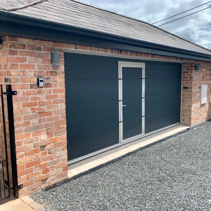 Black Wide Ribbed Sectional Garage Door with Door